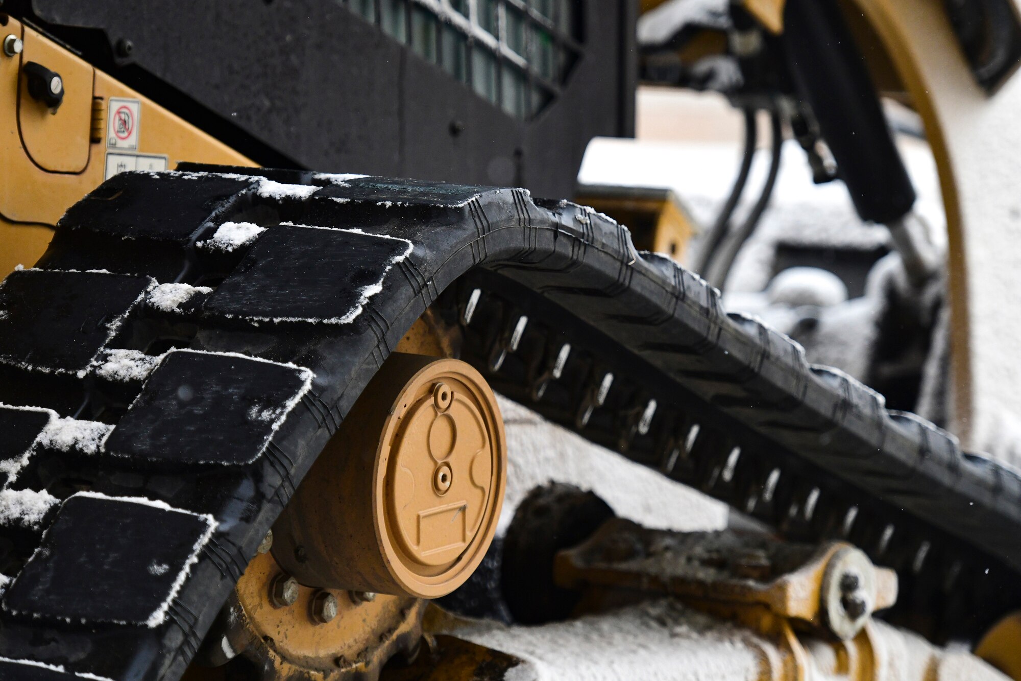 An Airman removes snow on the flightline.