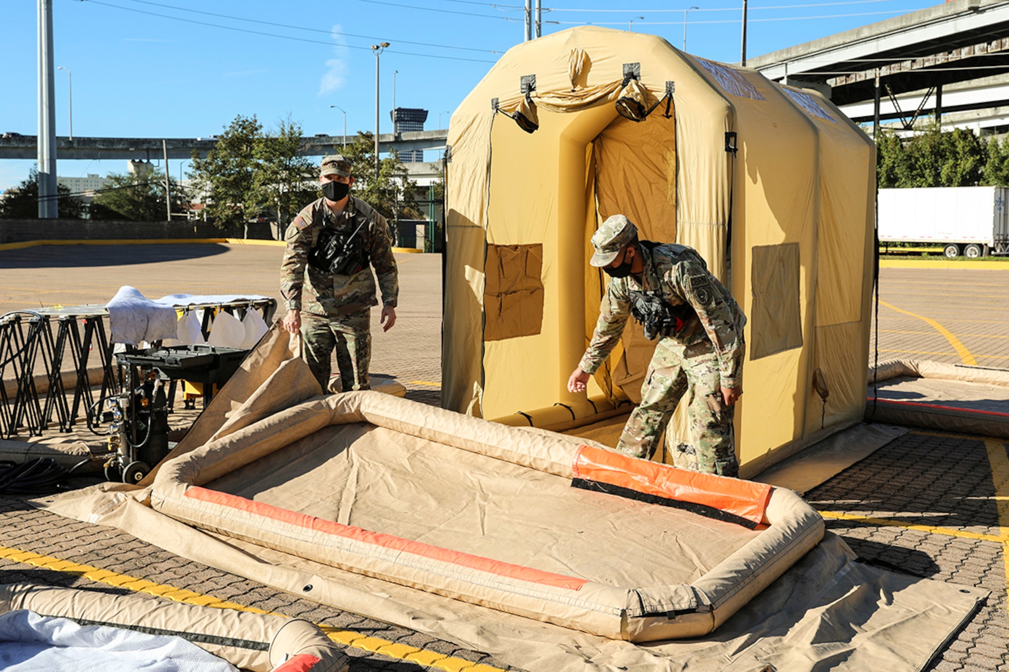 The Louisiana National Guard's 62nd Civil Support Team (CST) Weapons of Mass Destruction sets up a decontamination line as part of a joint simulated training exercise with the Iowa National Guard’s 71st CST in New Orleans, Jan. 11, 2022.