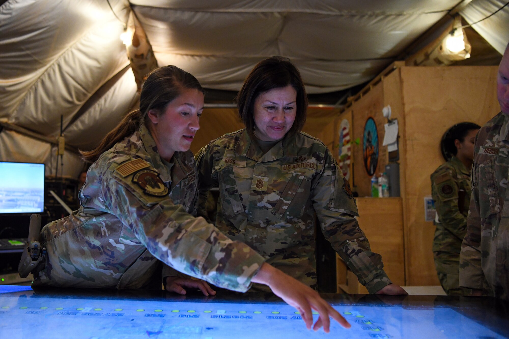 Senior Airman Madison Mortiz briefs Chief Master Sgt. of the Air Force JoAnne S. Bass about the Windows Team Assistance Kit