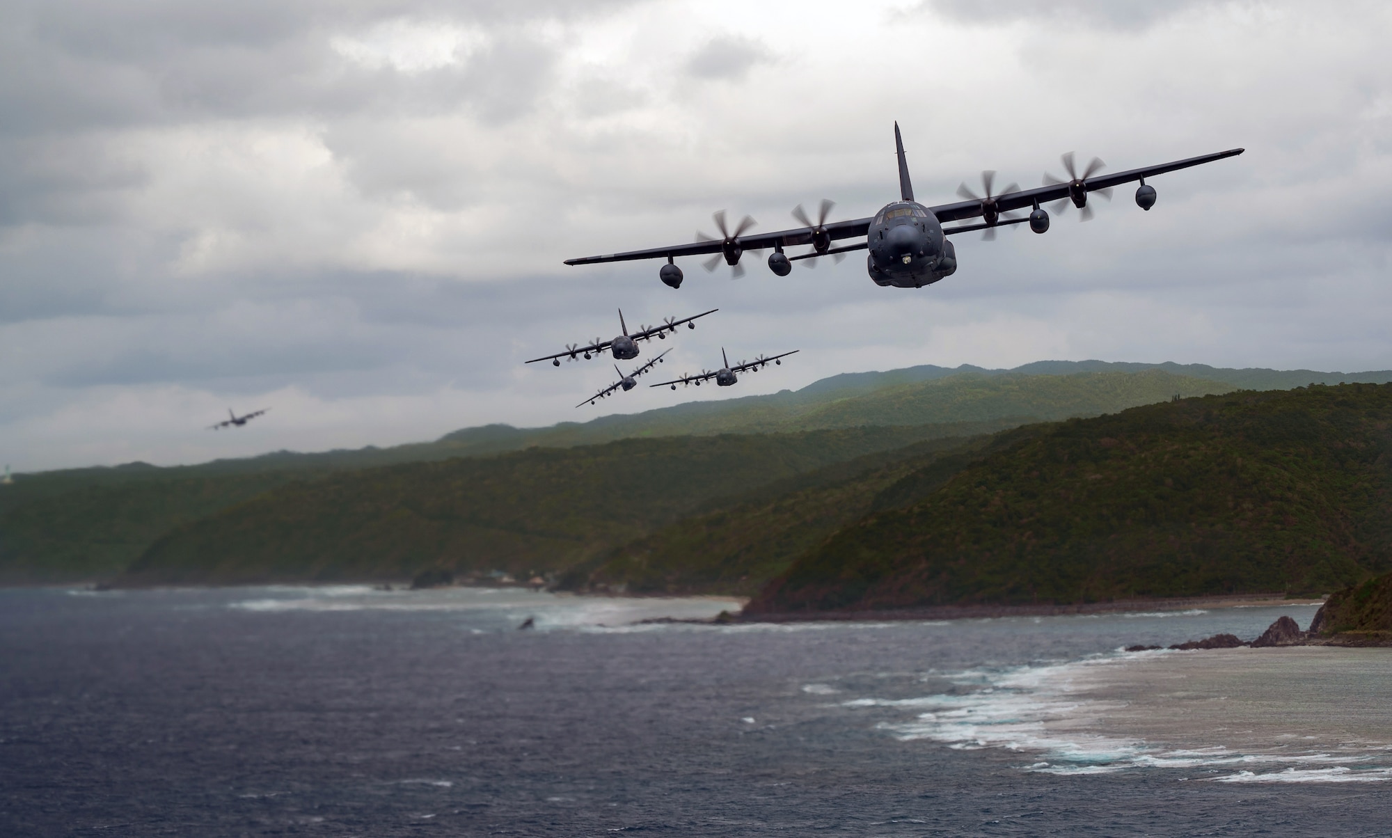 MC-130J Commando IIs fly in formation off the coast of Okinawa, Japan