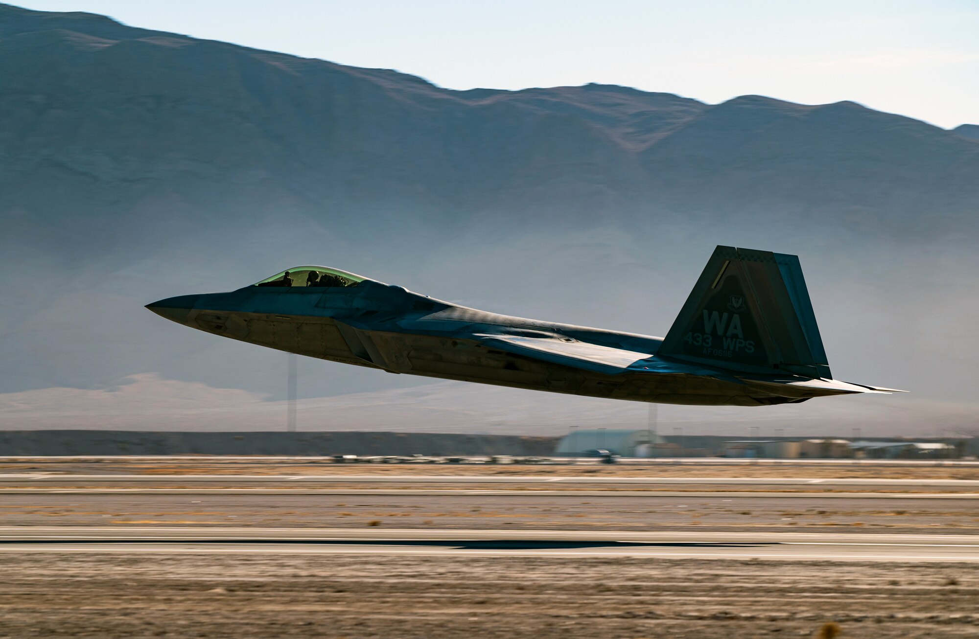 An F-22 Raptor takes off for a training mission