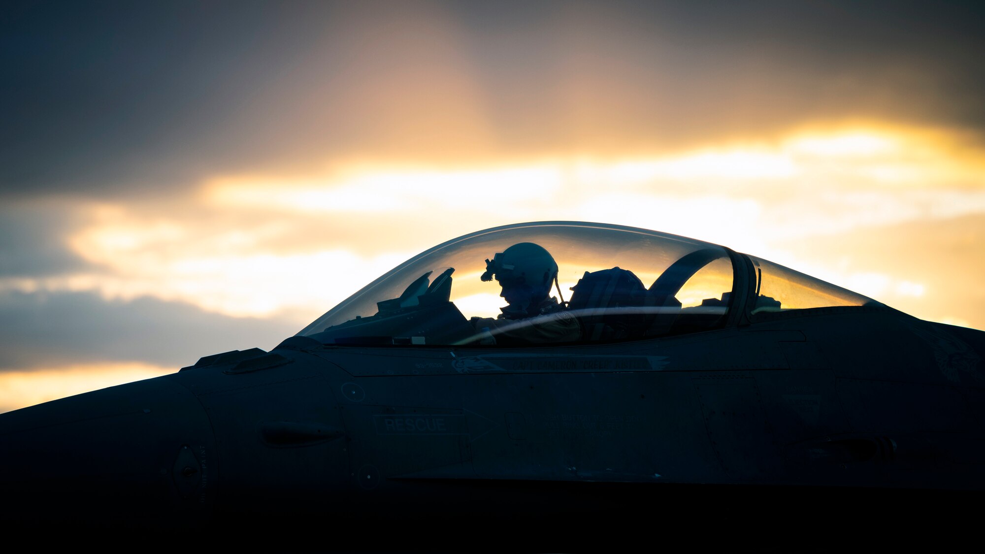 A U.S. Air Force F-16 Fighting Falcon pilot waits on the flightline