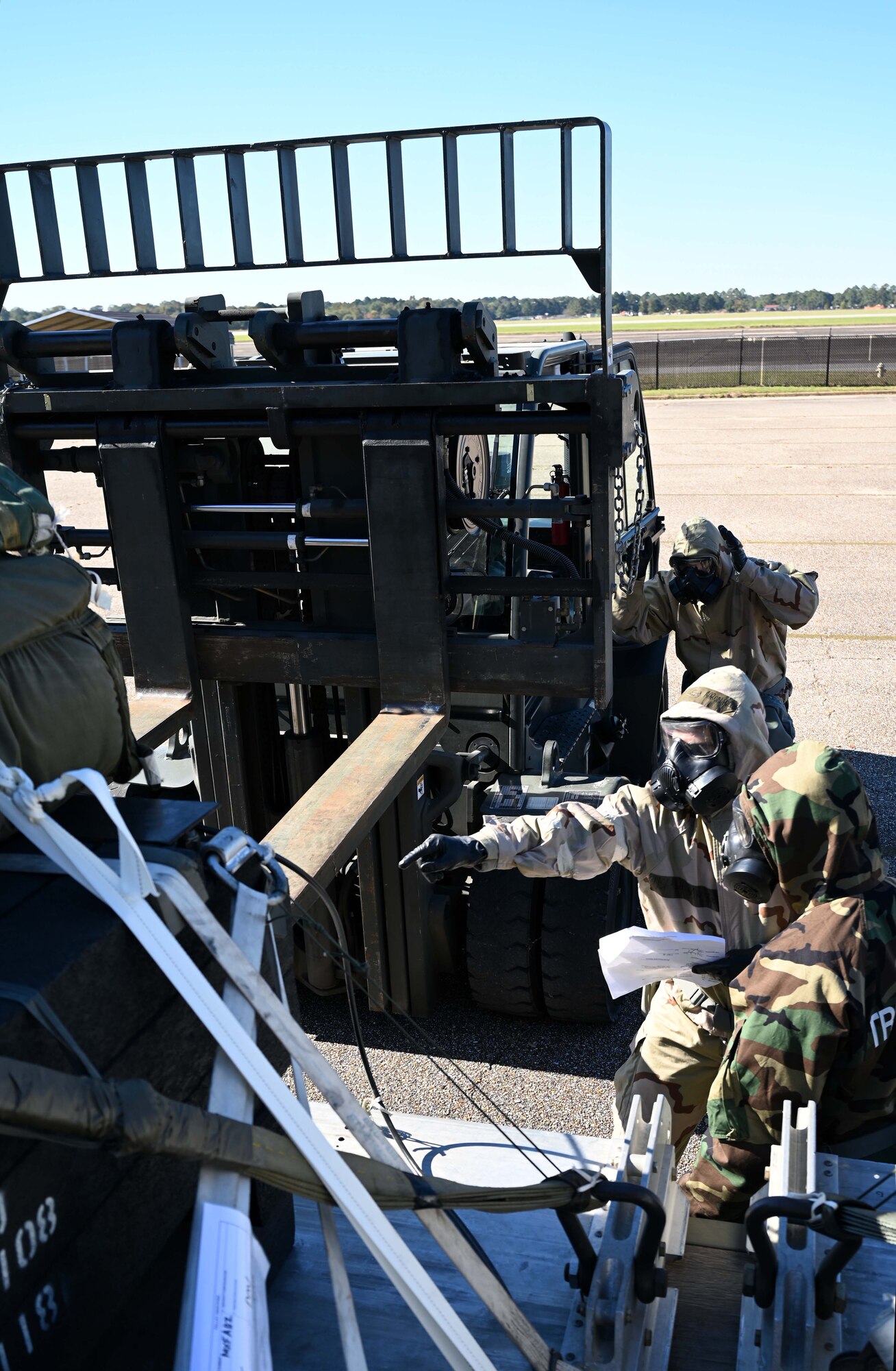 airmen direct a forklift