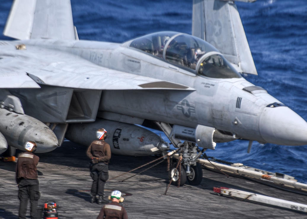 Sailors conduct pre-flight checks on an F/A-18F Super Hornet, assigned to the “Bounty Hunters”  of Strike Fighter Squadron (VFA) 2, on the flight deck of Nimitz-class aircraft carrier USS Carl Vinson (CVN 70), Jan. 15, 2022.