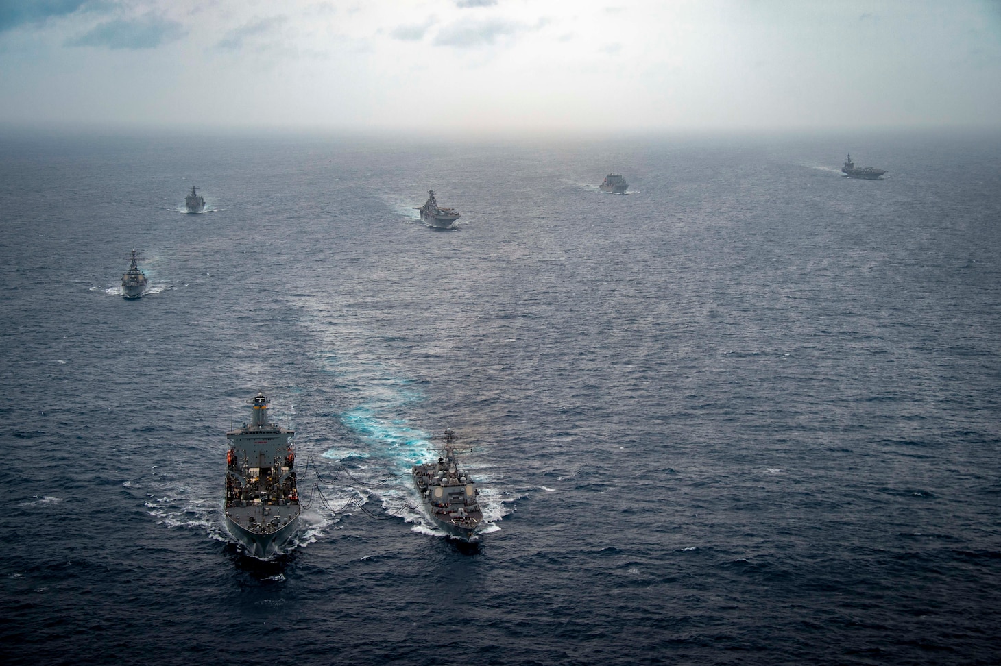 Henry J. Kaiser-class fleet replenishment oiler USNS John Ericsson (T-AO 194) conducts a replenishment-at-sea with Arleigh Burke-class guided-missile destroyer USS Michael Murphy (DDG 112) while transiting with Carl Vinson Carrier Strike Group (VINCSG) and Essex Amphibious Ready Group (ESX ARG) in the South China Sea, Jan. 13, 2022. VINCSG and ESX ARG are conducting joint expeditionary strike force operations in the South China Sea as part of continuing and routine interoperability training operations in the Indo-Pacific region.