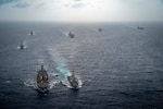 Henry J. Kaiser-class fleet replenishment oiler USNS John Ericsson (T-AO 194) conducts a replenishment-at-sea with Arleigh Burke-class guided-missile destroyer USS Michael Murphy (DDG 112) while transiting with Carl Vinson Carrier Strike Group (VINCSG) and Essex Amphibious Ready Group (ESX ARG) in the South China Sea, Jan. 13, 2022. VINCSG and ESX ARG are conducting joint expeditionary strike force operations in the South China Sea as part of continuing and routine interoperability training operations in the Indo-Pacific region.
