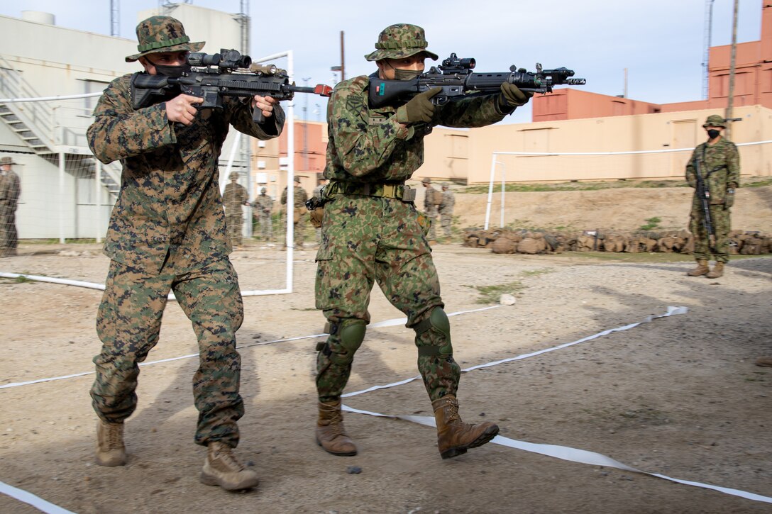 U.S. Marine Corps Pfc. Frank Ward, left, a rifleman with 3rd Platoon, Golf Company, 2nd Battalion, 4th Marine Regiment, 1st Marine Division, and a Japan Ground Self-Defense Force (JGSDF) soldier with 2nd Amphibious Rapid Deployment Regiment conduct bilateral hallway engagement training during exercise Iron Fist 2022 at Marine Corps Base Camp Pendleton, California, Jan. 12, 2022. For almost two decades the U.S. Marine Corps, U.S. Navy, and JGSDF have conducted exercise Iron Fist, training together in amphibious operations and affirming the U.S. commitment to our allies. (U.S. Marine Corps photo by Cpl. Aidan Hekker)