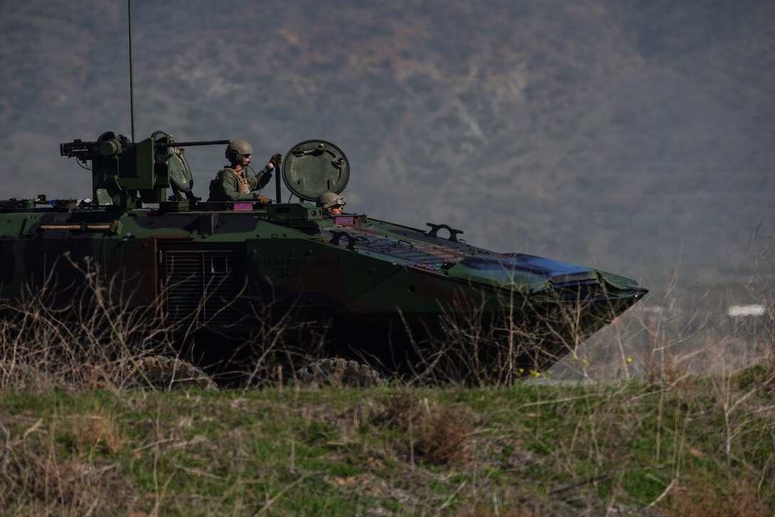 U.S. Marines with 1st Platoon, Charlie Company, 3rd Assault Amphibian Battalion, 1st Marine Division, hold a support-by-fire position in an amphibious combat vehicle during exercise Iron Fist 2022 at White Beach, Marine Corps Base Camp Pendleton, California, Jan. 14, 2022. For almost two decades the U.S. Marine Corps, U.S. Navy, and Japan Ground Self-Defense Force have conducted exercise Iron Fist, training together in amphibious operations and affirming the U.S. commitment to our allies. (U.S. Marine Corps photo by Cpl. Sydney Smith)