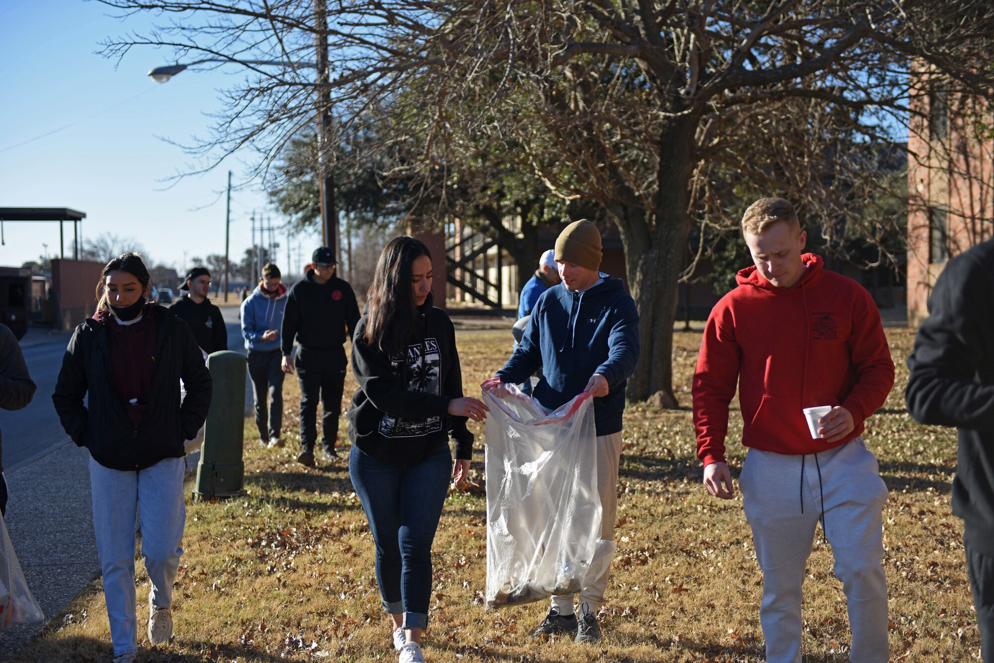 U.S. Air Force Airmen and Space Force Guardians assigned to Goodfellow Air Force Base pick up trash on Goodfellow AFB, January 17, 2022. Students volunteered their time to clean up the base. (U.S. Air Force photo by Airman 1st Class Sarah Williams)