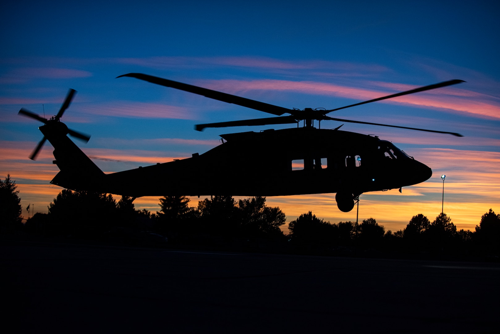 A new UH-60M Black Hawk flies into the sunset at takeoff from Gowen Field, Idaho, Sept. 23, 2021. The Idaho National Guard has replaced 20 of its UH-60L Black Hawk helicopters with UH-60M Black Hawks.