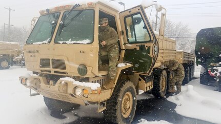 Spc. Leslie Rivera with the 1067th Composite Truck Company, 228th Transportation Battalion, 213th Regional Support Group, Pennsylvania Army National Guard, conducts preventive maintenance checks and services on her Heavy Expanded Mobility Tactical Truck wrecker in preparation for mission support during Winter Storm Toby March 21 in Philadelphia.