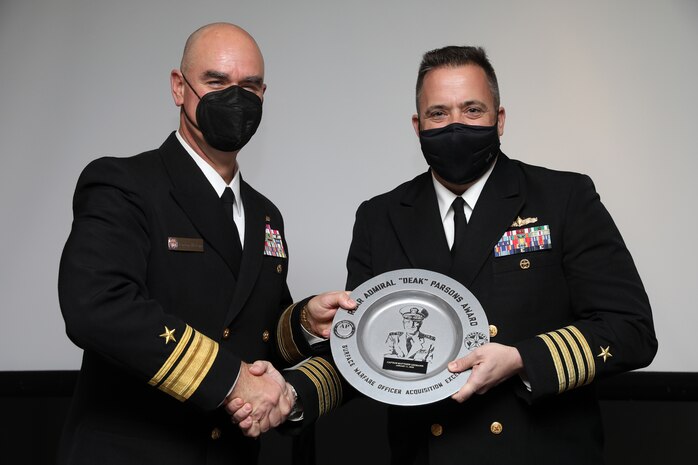 ARLINGTON, Va. (January 11, 2022) -- Rear Admiral Brendan McLane, Commander, Naval Force Atlantic (L) presents the Admiral Parsons Award to Capt. Matt Lehmann, PAPM (R) at the Surface Navy Association 34th National Symposium in Arlington, Virginia.