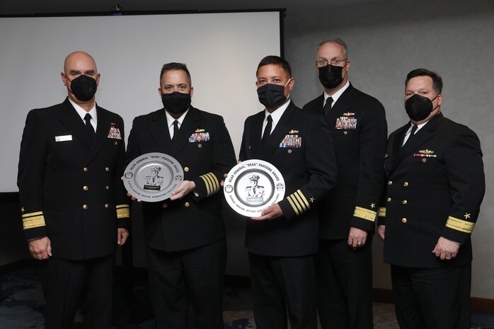 ARLINGTON, Va (January 11, 2022) -- Rear Admiral Brendan McLane, Commander, Naval Force Atlantic (L) presents the Admiral Parsons Award to Capt. Matt Lehmann, PAPM and Capt. Khary Hembree-Bey, MPM, with Rear Admiral Eric H. Ver Hage, Commander, Navy Regional Maintenance Center and Director, Surface Ship Maintenance, Modernization, and Sustainment, and Rear Admiral Tom Druggan, Commander, Naval Surface Warfare Center (NSWC), at the Surface Navy Association 34th National Symposium in Arlington, VA. (U.S. Navy photo by Laura Lakeway)