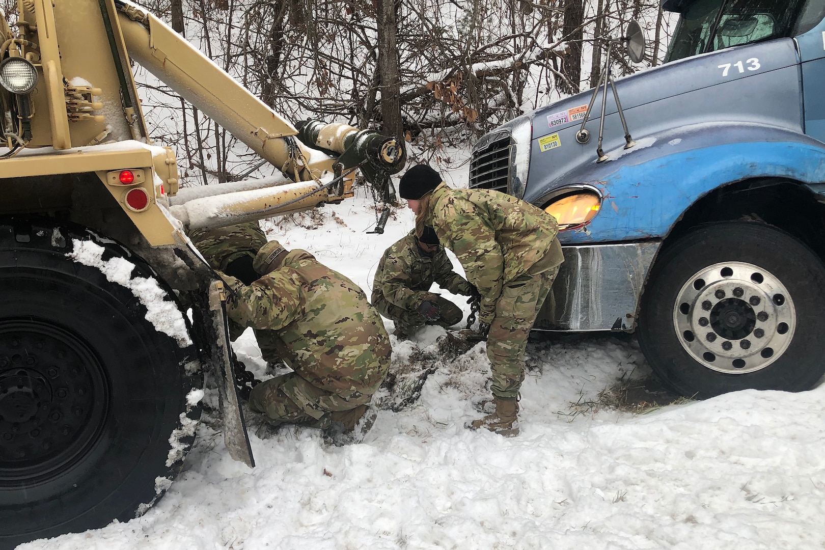 Soldiers of the North Carolina National Guard's 113th Sustainment Brigade. 1452nd Combat HET Transportation Company, help stranded motorists in Surry County, North Carolina, during Winter Storm Izzy, Jan. 16, 2022. The Soldiers are assigned to All Hazard Response Teams and other force packages to support local authorities’ winter storm response.