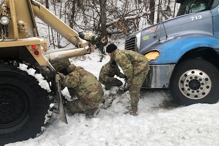 Soldiers of the North Carolina National Guard's 113th Sustainment Brigade. 1452nd Combat HET Transportation Company, help stranded motorists in Surry County, North Carolina, during Winter Storm Izzy, Jan. 16, 2022. The Soldiers are assigned to All Hazard Response Teams and other force packages to support local authorities’ winter storm response.