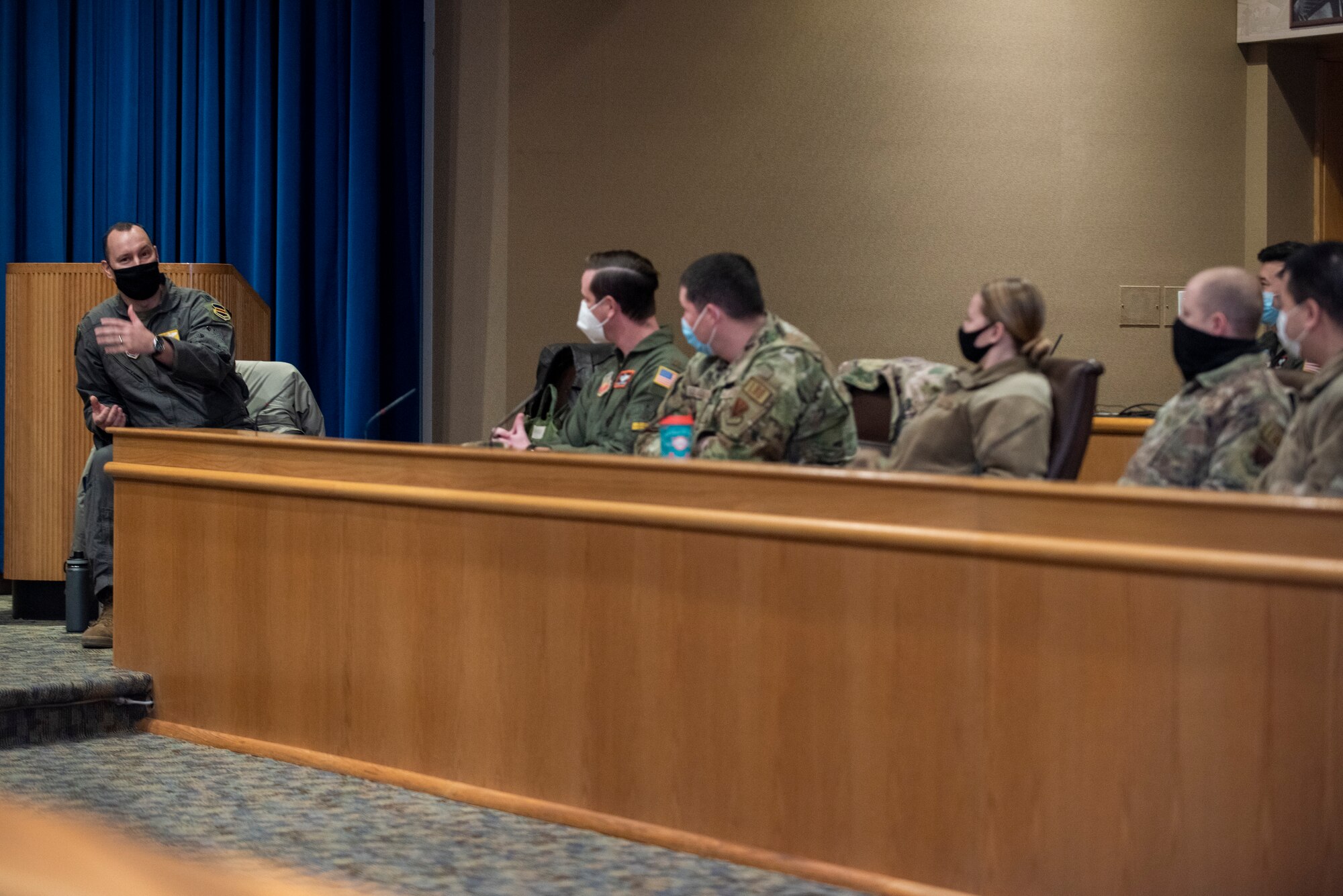 A squadron commander talks to a row of attendees at at Road to Squadron Command panel