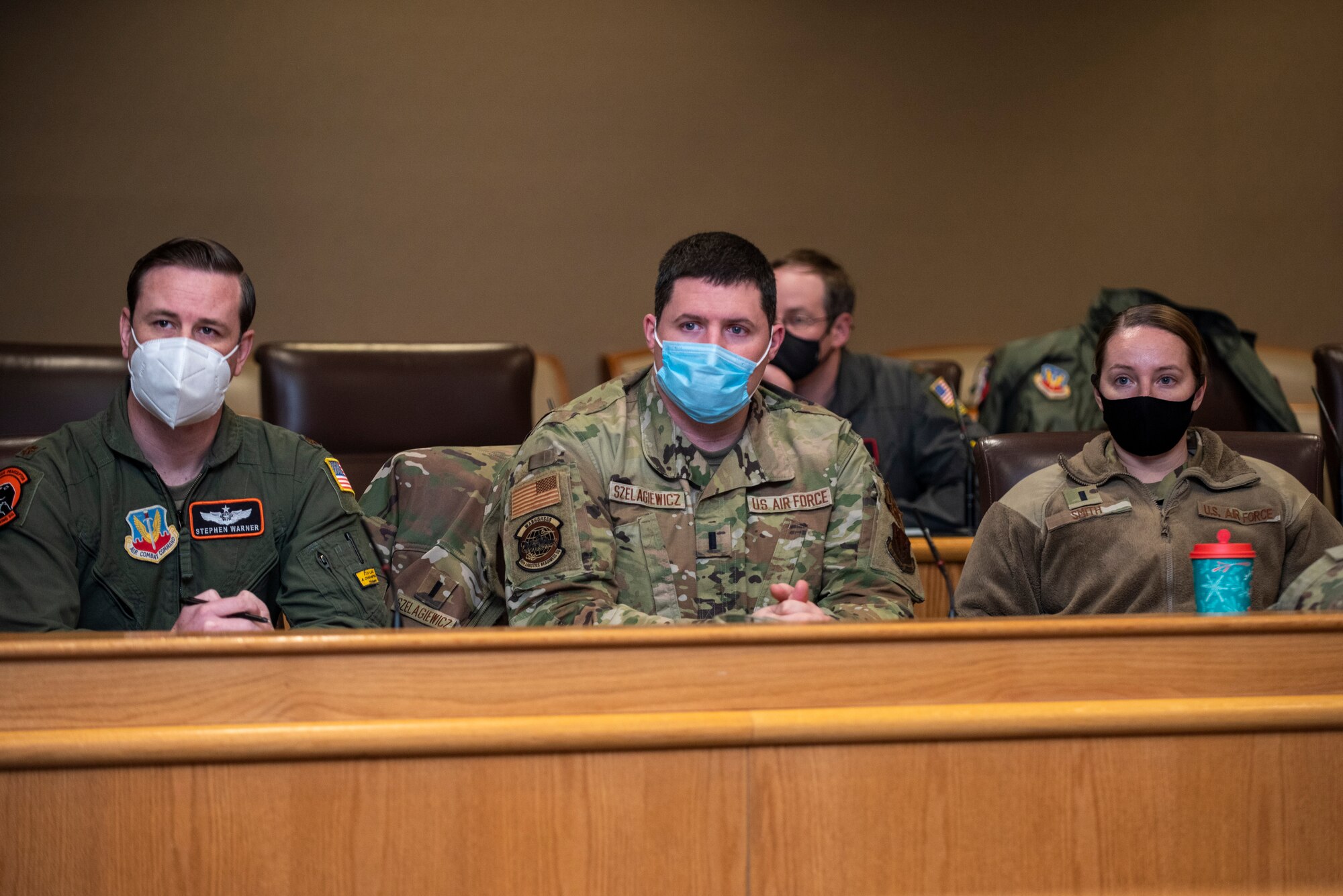 A group of three junior officers interested in squadron command listen during a Road to Squadron Command panel