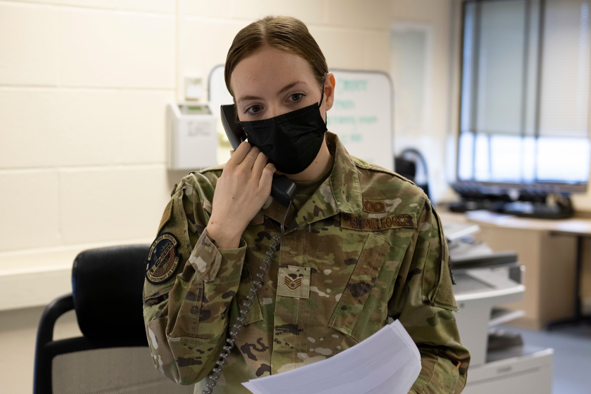 U.S. Air Force Staff Sgt. Kaitlin Flick, 420th Expeditionary Air Base Squadron airfield management operations supervisor, receives a call at Royal Air Force Fairford, England, Jan. 11, 2022. Members of the 420th EABS, deployed from around the world, work  together with the 420th Air Base Squadron to support various missions at Fairford. From Jan. 8-12, the 420th EABS provided support for the 352nd Special Operations Wing’s Agile Combat Employment exercise. ACE exercises prepare Airmen to operate effectively from locations with varying levels of capacity and support. (U.S. Air Force photo by Senior Airman Jennifer Zima)