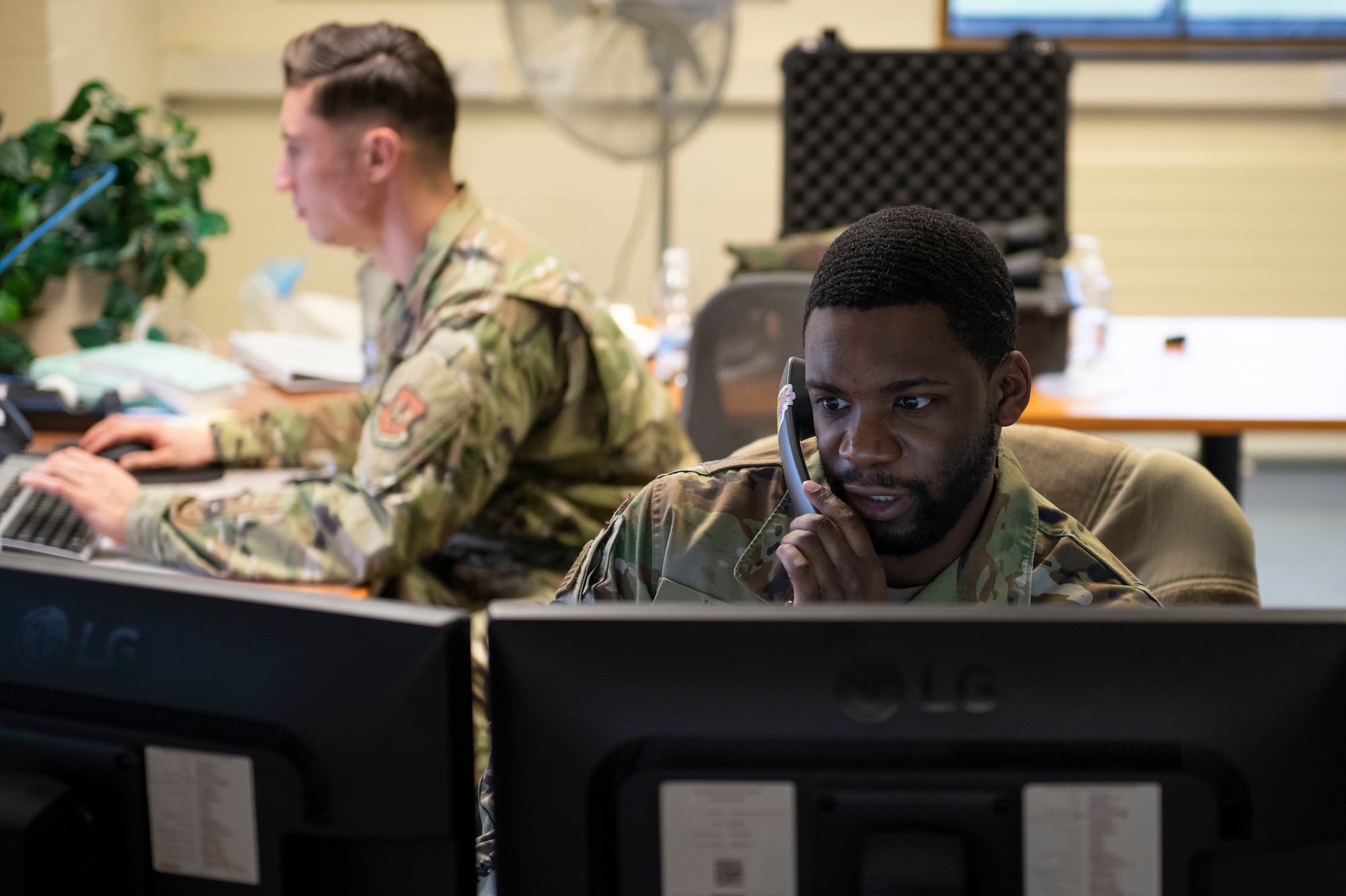 U.S. Air Force Senior Airman Nadir White, 420th Expeditionary Air Base Squadron forecaster, receives a call at Royal Air Force Fairford, England, Jan. 11, 2022. Members of the 420th EABS, deployed from around the world, work  together with the 420th Air Base Squadron to support various missions at Fairford. From Jan. 8-12, the 420th EABS provided support for the 352nd Special Operations Wing’s Agile Combat Employment exercise. ACE exercises prepare Airmen to operate effectively from locations with varying levels of capacity and support. (U.S. Air Force photo by Senior Airman Jennifer Zima)