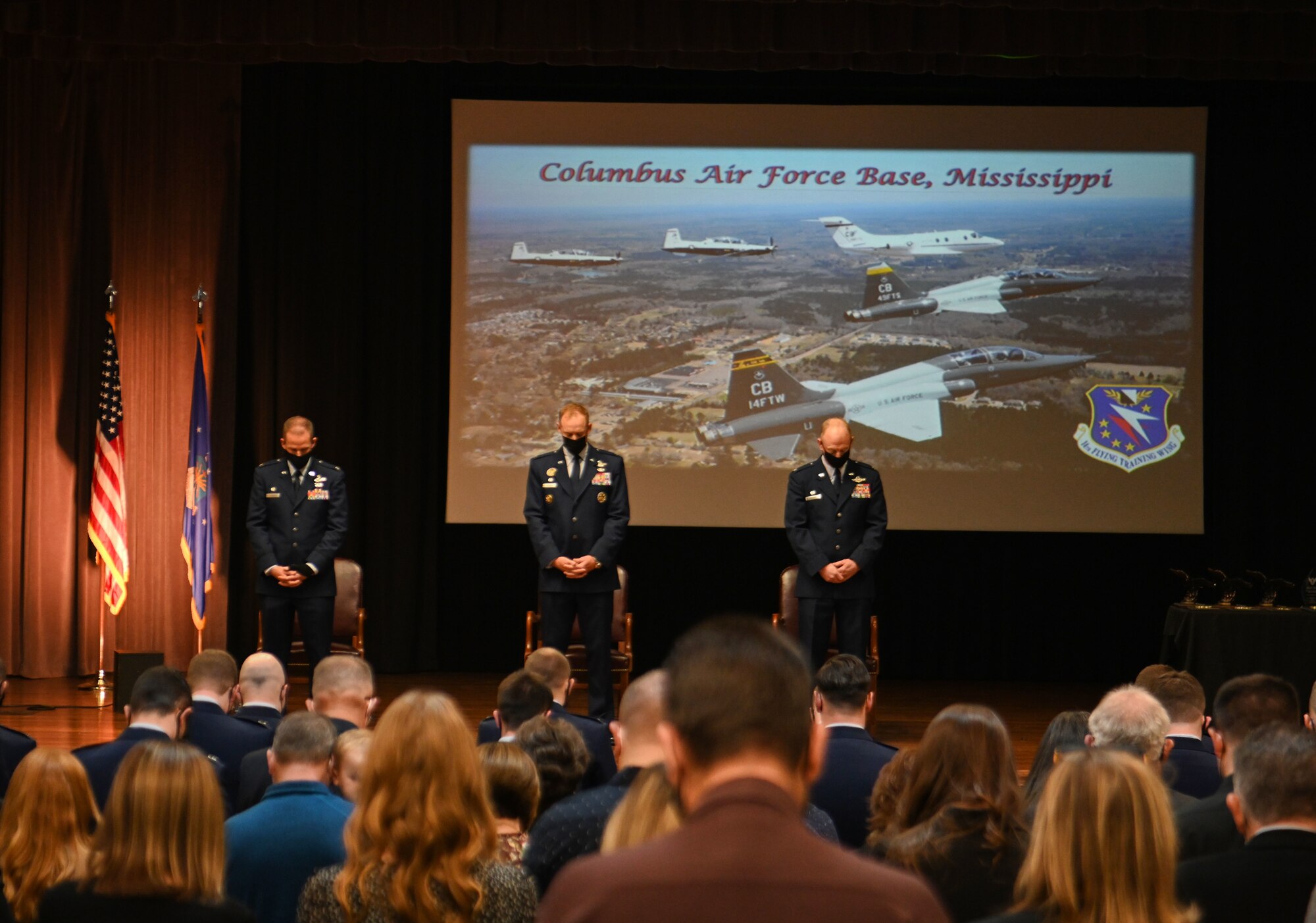 Col. Seth Graham, 14th Flying Training Wing commander, Col. Benjamin Jonsson, 6th Air Refueling Wing commander, and Col. Justin Spears, 14th Operations Group commander, bow their heads on Jan. 14, 2022, at Columbus Air Force Base, Miss. Graduates of Specialized Undergraduate Pilot Training have to complete a demanding 52-week course, comprised of academics, physiological training, and flight training in the T-6A Texan II, T-1A Jayhawk, and T-38C Talon. (U.S. Air Force photo by Senior Airman Davis Donaldson)
