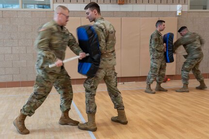 Spc. Jeremy Wilkens, left, practices baton tactics on a strike shield held by Spc. Greg Marquis, both from the 237th Military Police Company, Jan. 7, 2022, at the Edward Cross Training Center, Pembroke, New Hampshire. Two dozen New Hampshire National Guardsmen from three units will help secure the state's prisons as part of Operation Winter Surge.