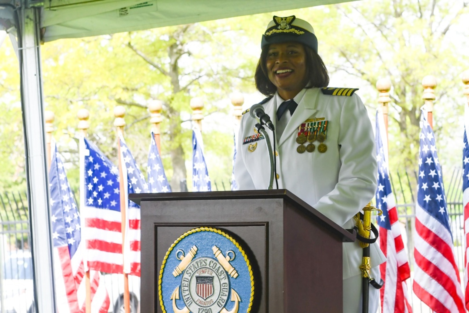 Capt. Zeita Merchant, wearing the female service dress white uniform, relieved Capt. Jason Tama as the commanding officer of Coast Guard Sector New York during a change-of-command ceremony at Sector New York, May 7, 2021. A change-of-command ceremony is a time-honored tradition conducted before the assembled crew, as well as honored guests and dignitaries to formally demonstrate the continuity of the authority within a command. (U.S. Coast Guard Photo by Petty Officer 3rd Class Ryan Schultz)