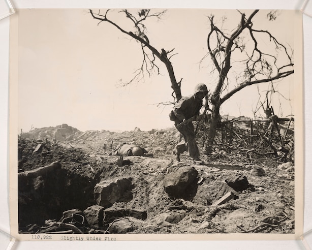 A Marine Combat Engineer sets off a satchel charge that blasts a