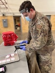 Minnesota National Guard Staff Sgt. John O'Donnell,148th Fighter Wing Explosive Ordnance Disposal technician, provides COVID-19 testing support at a community-based testing site at the Hibbing, Minnesota, armory December 20, 2021.  The Minnesota National Guard is partnering with the Minnesota Department of Health to staff COVID-19 testing sites across Minnesota.