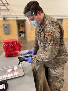 Minnesota National Guard Staff Sgt. John O'Donnell,148th Fighter Wing Explosive Ordnance Disposal technician, provides COVID-19 testing support at a community-based testing site at the Hibbing, Minnesota, armory December 20, 2021.  The Minnesota National Guard is partnering with the Minnesota Department of Health to staff COVID-19 testing sites across Minnesota.