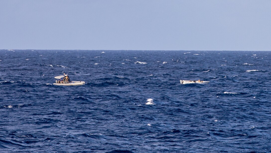 U.S. Navy Sailors on a small boat wait on scene with a suspected drug smuggling go-fast vessel (GFV) during a drug interdiction operation, Jan. 7, 2021.