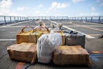 Approximately 315 kilograms of suspected cocaine sits on the flight deck of  USS Milwaukee.