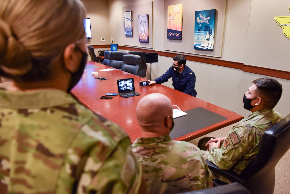 U.S. Air Force Staff Sgt. Samuel Cervantez, 17th Civil Engineer non-commissioned officer in charge of plans and operations for the Office of Emergency Management, Col. Matthew Reilman, 17th Training Wing commander, and Chief Master Sgt. Rebecca Arbona, 17th TRW command chief, participate in a teleconference with Secretary of the Air Force Frank Kendall, on Goodfellow Air Force Base, Texas, Jan. 11, 2022. The Senior Leader Enlisted Commissioning Program allows senior leaders to directly grant enlisted members an opportunity to commission through Officer Training School after showing leadership skills and exceptional performance. (U.S. Air Force photo by Staff Sgt. Jermaine Ayers)