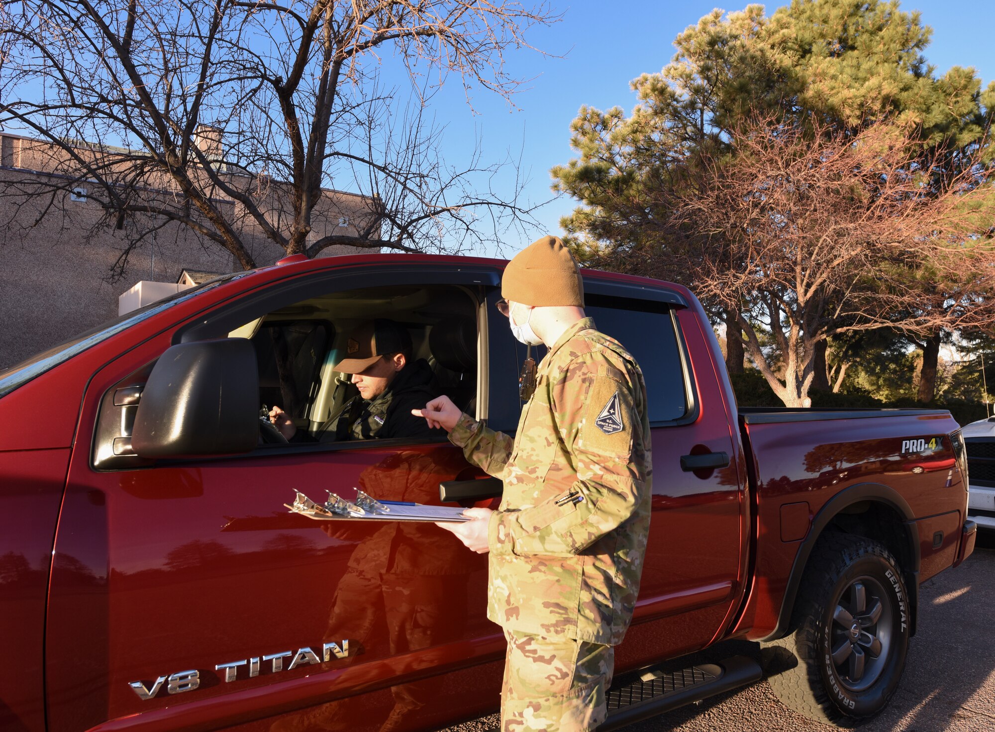 Man talks to person in truck.