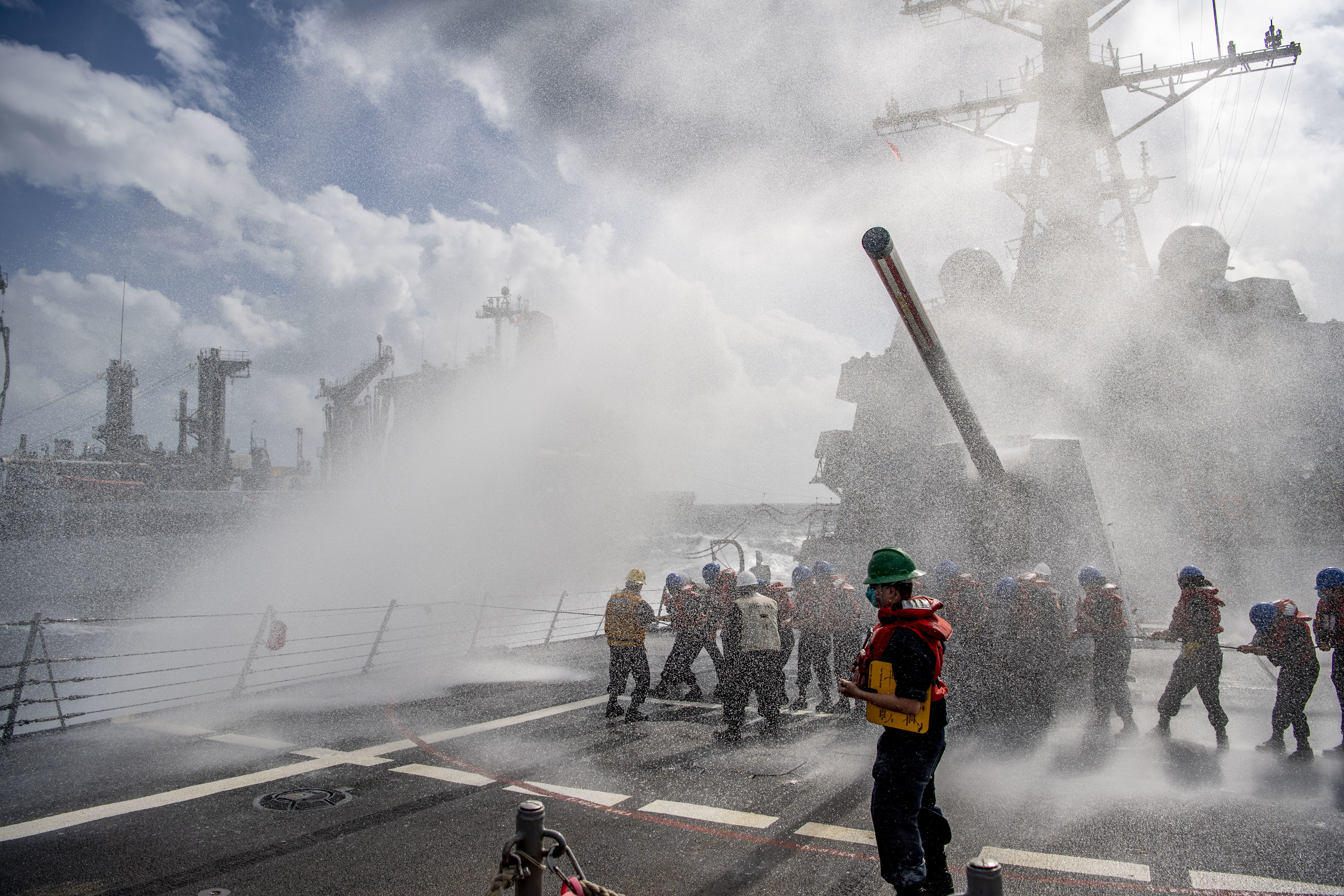 Sailors assigned to the Arleigh Burke-class guided-missile destroyer USS Dewey (DDG 105), hold the phone and distance line during a replenishment-at-sea with the Military Sealift Command fleet replenishment oiler USNS Yukon (T-AO 202).