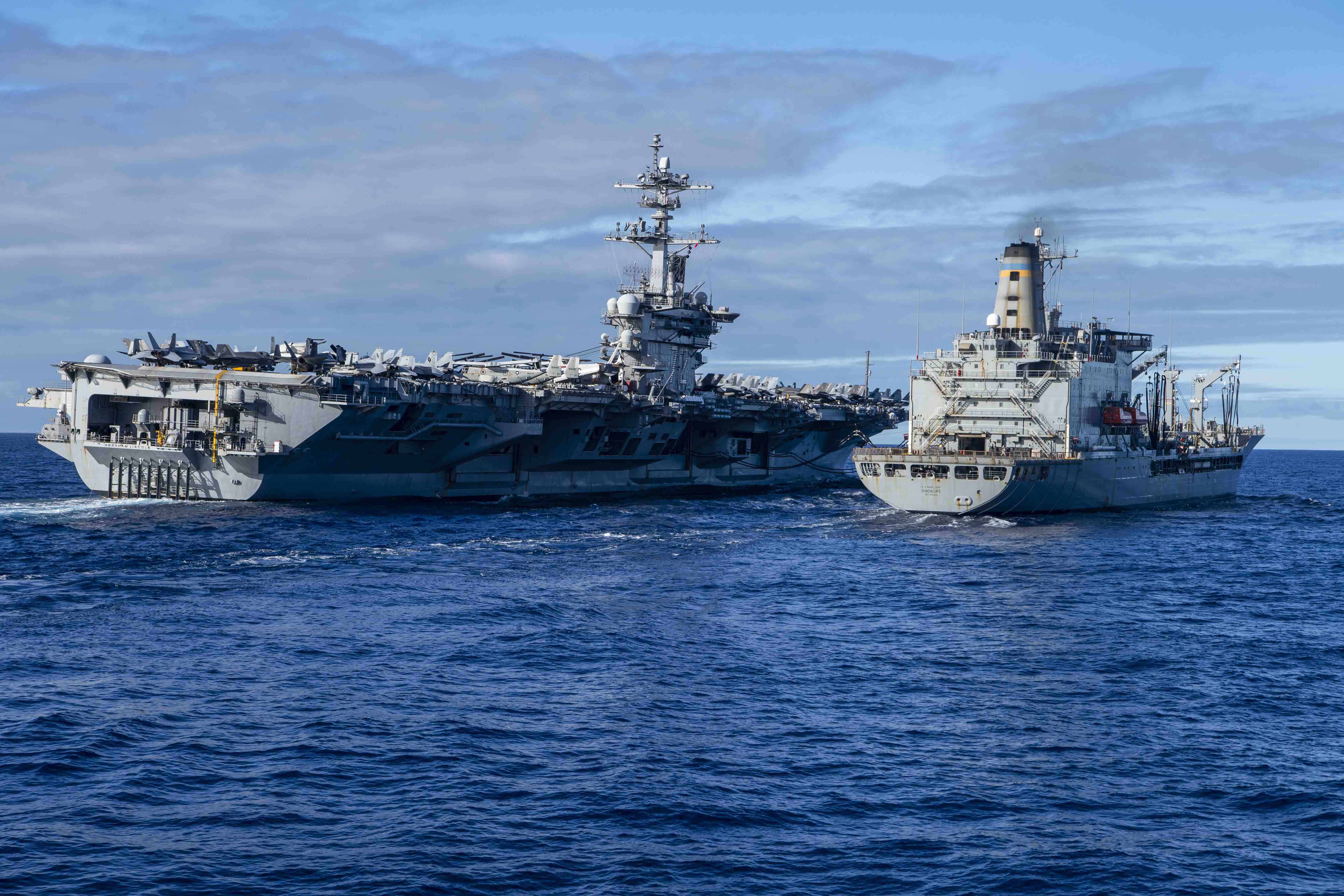 USS Abraham Lincoln (CVN 72) transits alongside the Military Sealift Command fleet replenishment oiler USNS Guadalupe (T-AO 200) during a replenishment-at-sea.