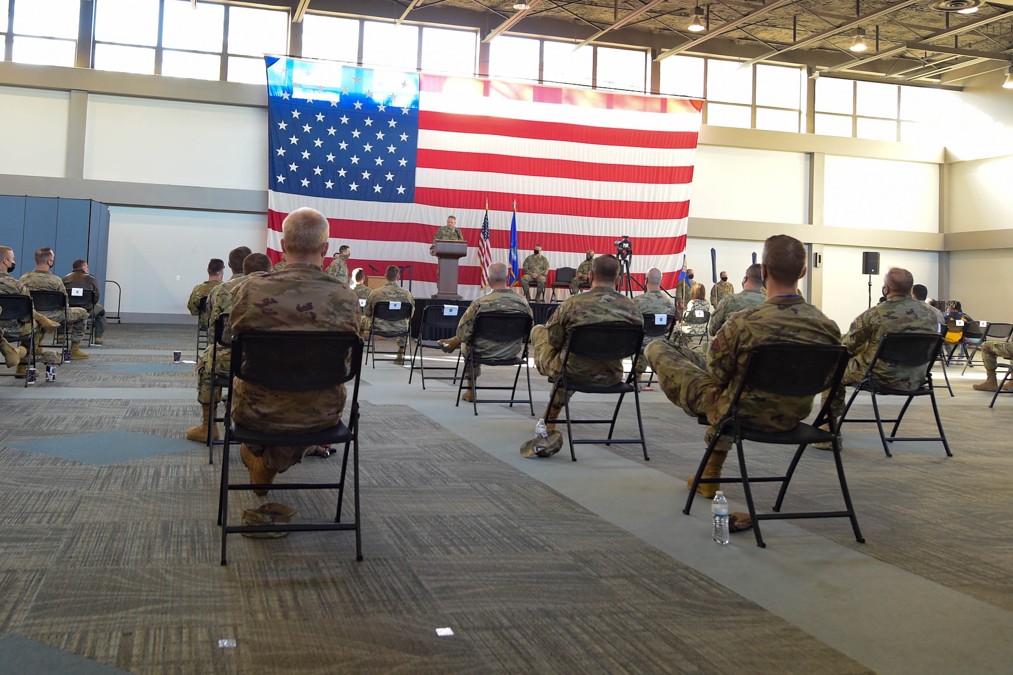 men sitting in chairs at a ceremony