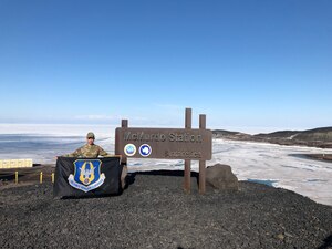 Senior Master Sgt. Joseph Coffey, 439th Aeromedical Squadron 1st Sgt., stands on top Castle Rock, McMurdo Station, Antarctica, Dec. 22, 2021. Coffey is the first Reserve 1st Sgt. to deploy to McMurdo Station in support of Operation DEEP FREEZE. (Courtesy photo)