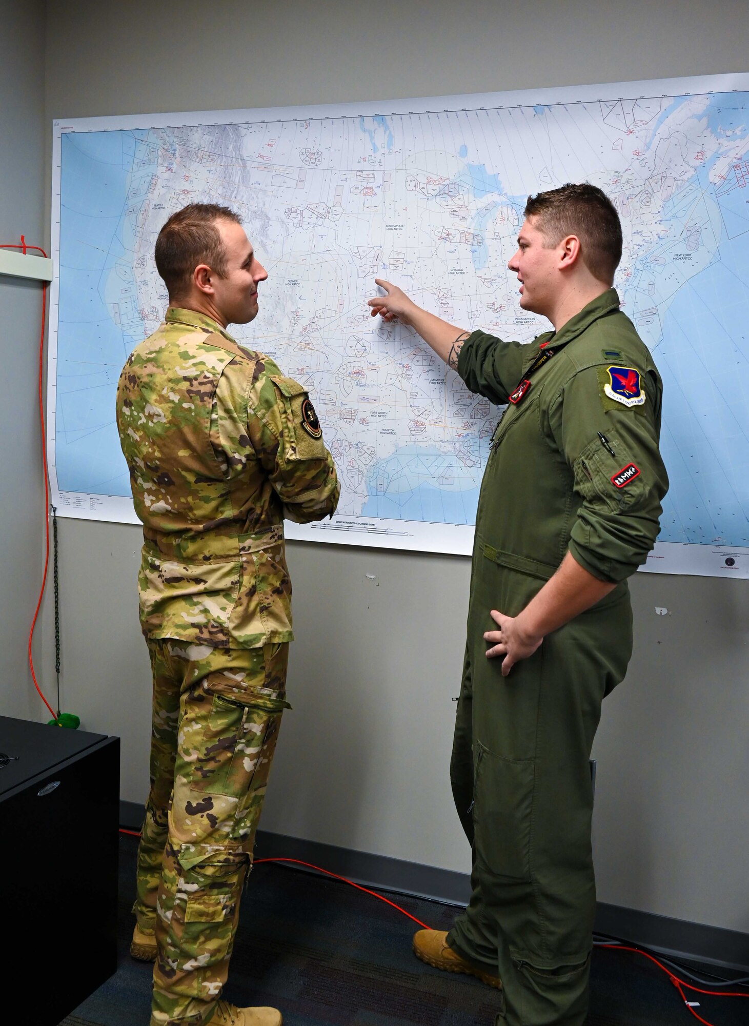 Two airmen looking at a map