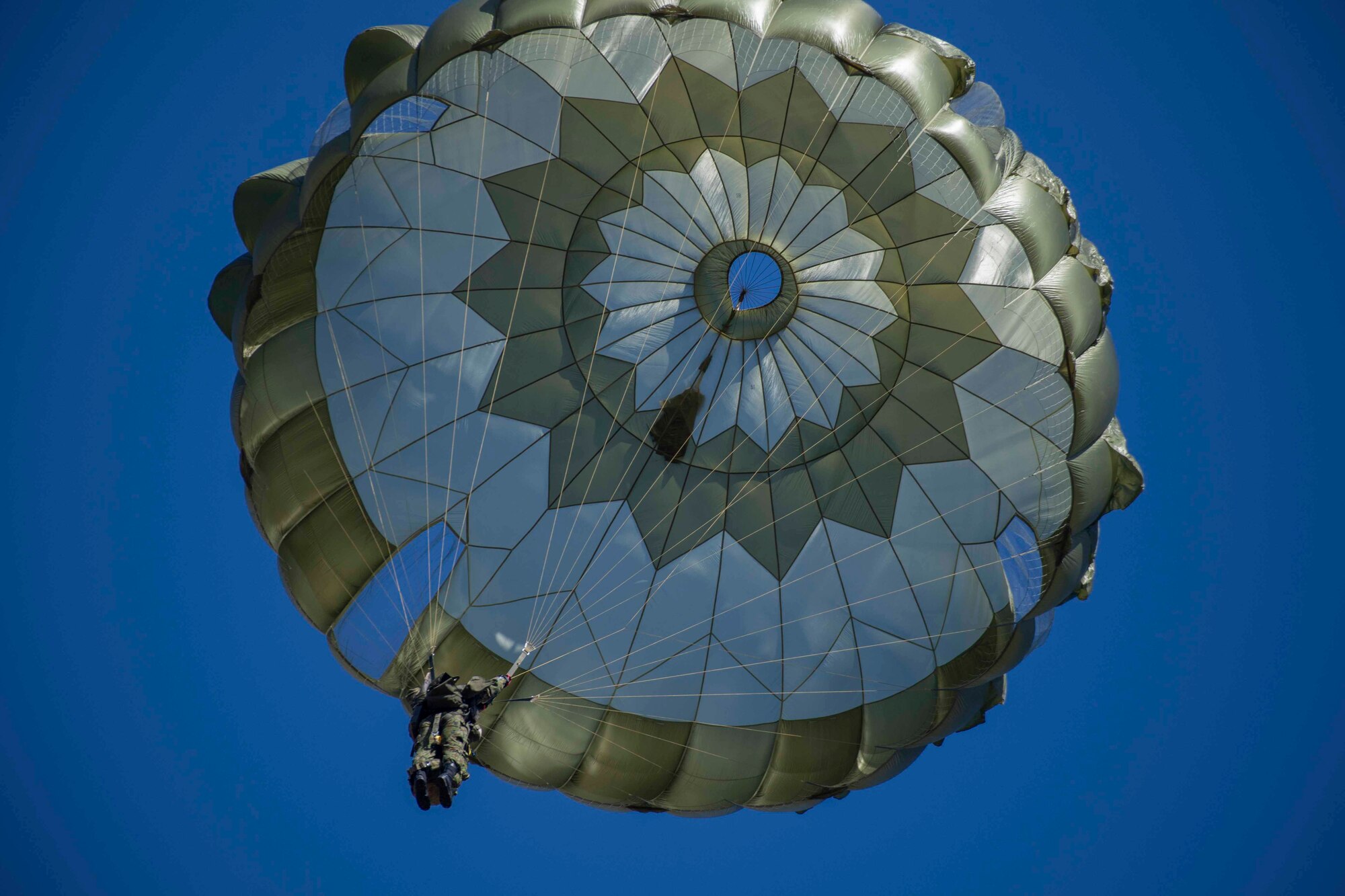 A Japan Ground Self-Defense Force paratrooper from the 1st Airborne Brigade, prepares to land in a drop zone