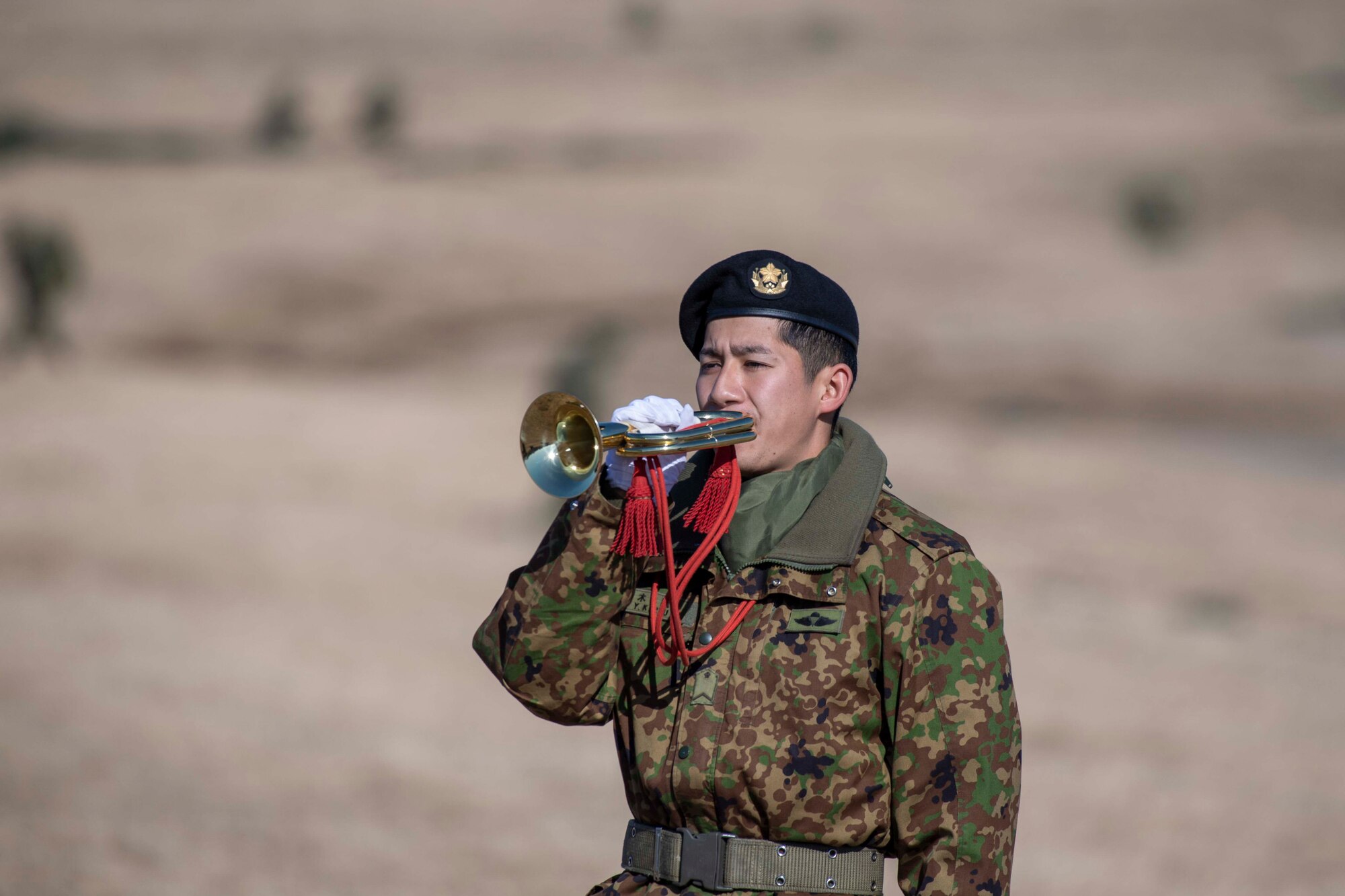A Japanese airborne trooper plays a bugle
