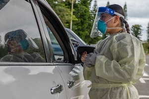 Airmen assigned to the 18th Medical Group conduct drive-through COVID-19 testing