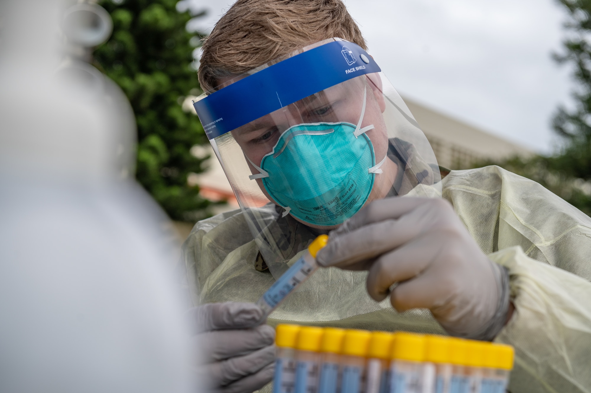 Airman holding test sample