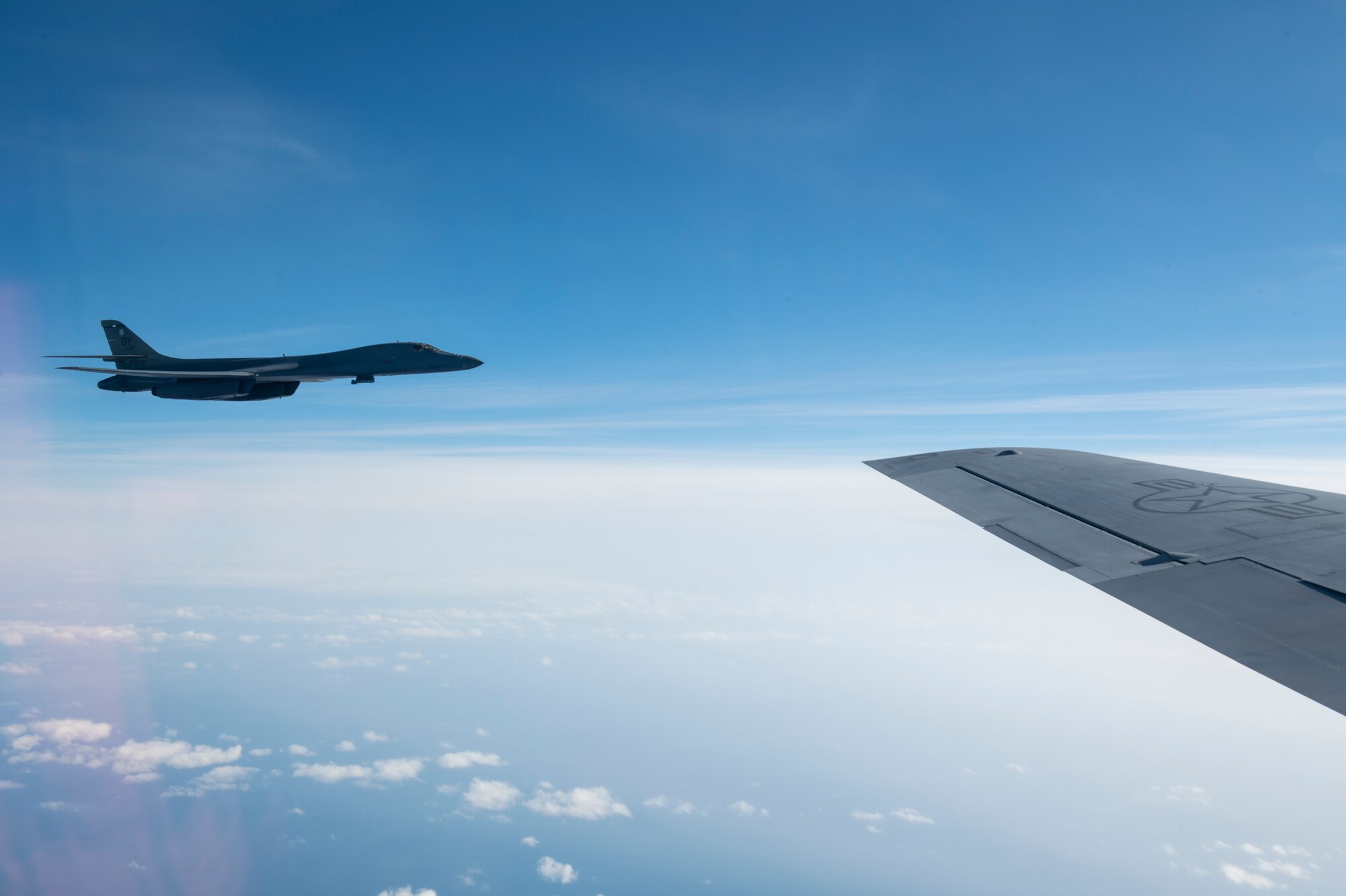 A B-1B Lancer from the 7th Bomb Wing departs after receiving fuel from a KC-135R Stratotanker over the Pacific Ocean