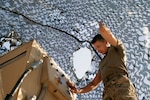 U.S. Army Spc. Corbin Doll, a forward observer with 1st Battalion, 194th Field Artillery, mans a Counter-Rocket, Artillery, Mortar gun at Al Asad Air Base, Iraq, on June 7, 2021. As a forward observer, Doll has been trained to help direct artillery and mortar fire. (U.S. Army National Guard photo by Sgt. 1st Class Christie R. Smith)