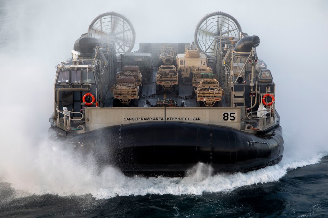 A U.S. Navy landing craft, air cusioned with Assault Craft Unit 4, transport the Ground Combat Element of the 22nd Marine Expeditionary Unit onto amphibious assault ship USS Kearsarge (LHD 3), for Composite Training Unit Exercise (COMPTUEX), Jan. 15, 2022. COMPTUEX is the last at-sea period of the ARG/MEU Predeployment Training Program. COMPTUEX is the final certifying step before the ARG/MEU team to demonstrate its readiness to deploy. (U.S. Marine Corps photo by Cpl. Yvonna Guyette)