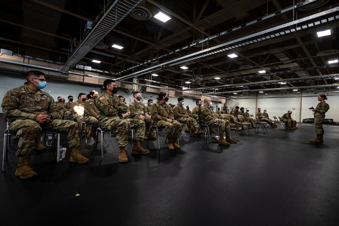 U.S. Air Force Capt. Sara Kucharski, an infectious disease specialist with the New Jersey National Guard, briefs Soldiers assigned to Joint Task Force Covid Guardian on Joint Base McGuire-Dix-Lakehurst, N.J., Jan. 13, 2022.