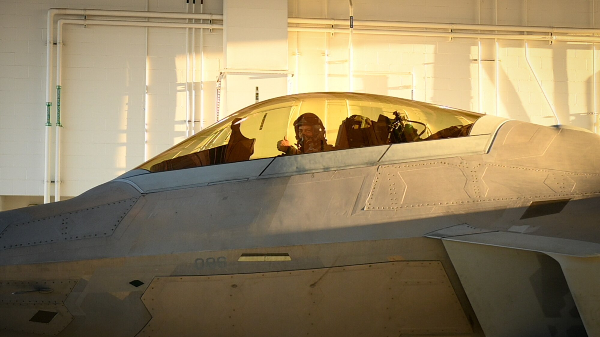 PACAF commander gives a thumbs up before taxi in an F-22 Raptor aircraft.