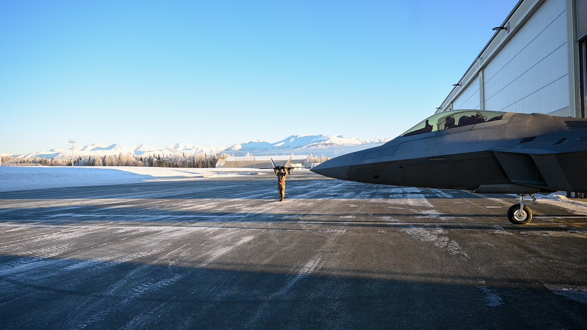 PACAF commander taxis an F-22 Raptor aircraft.