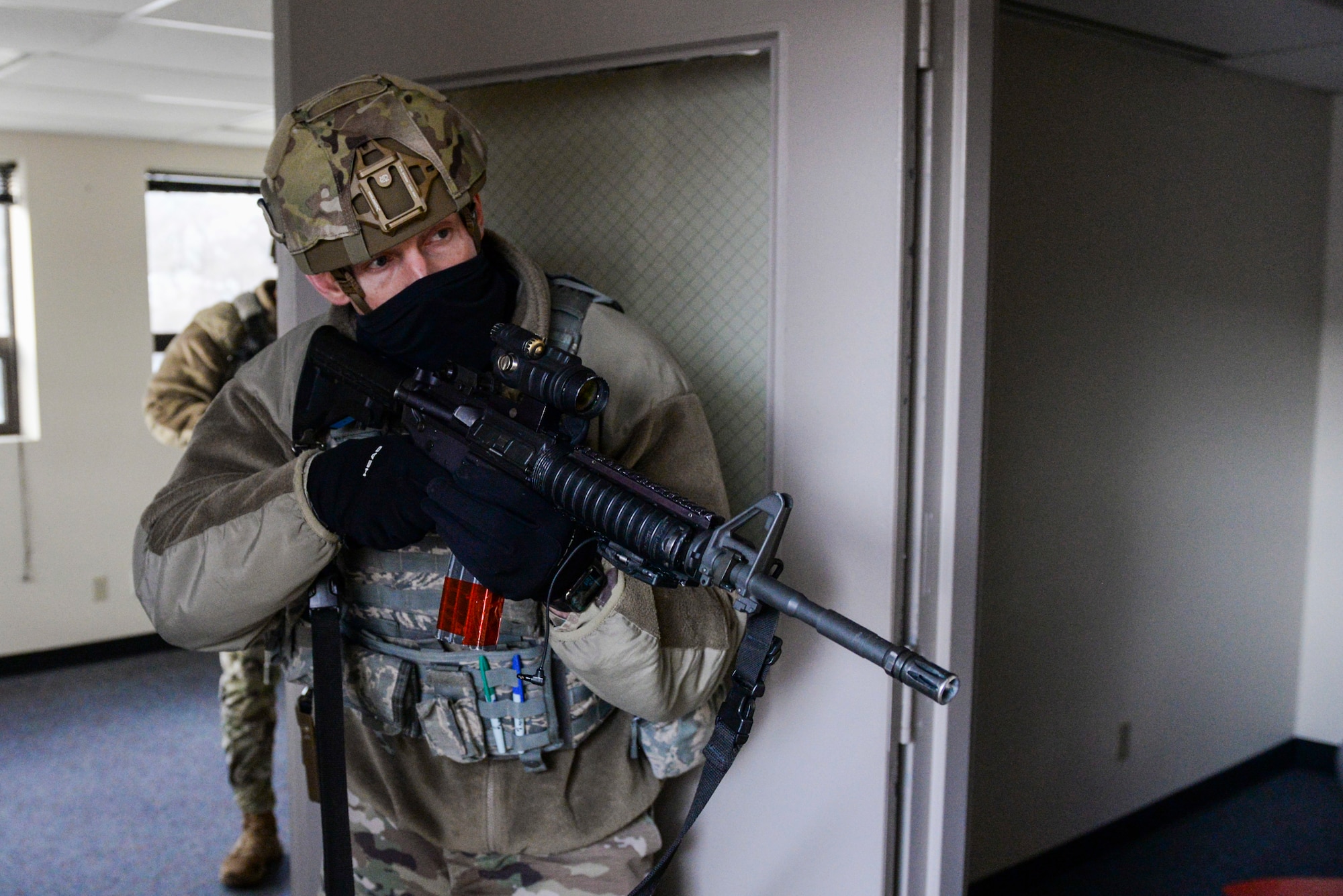A member of the 88th Security Forces Squadron secures a room during an active-shooter exercise at Wright-Patterson Air Force Base, Ohio, Feb. 24, 2021. Readiness exercises are routinely held to streamline unit cohesion when responding to emergencies. (U.S. Air Force photo by Wesley Farnsworth)