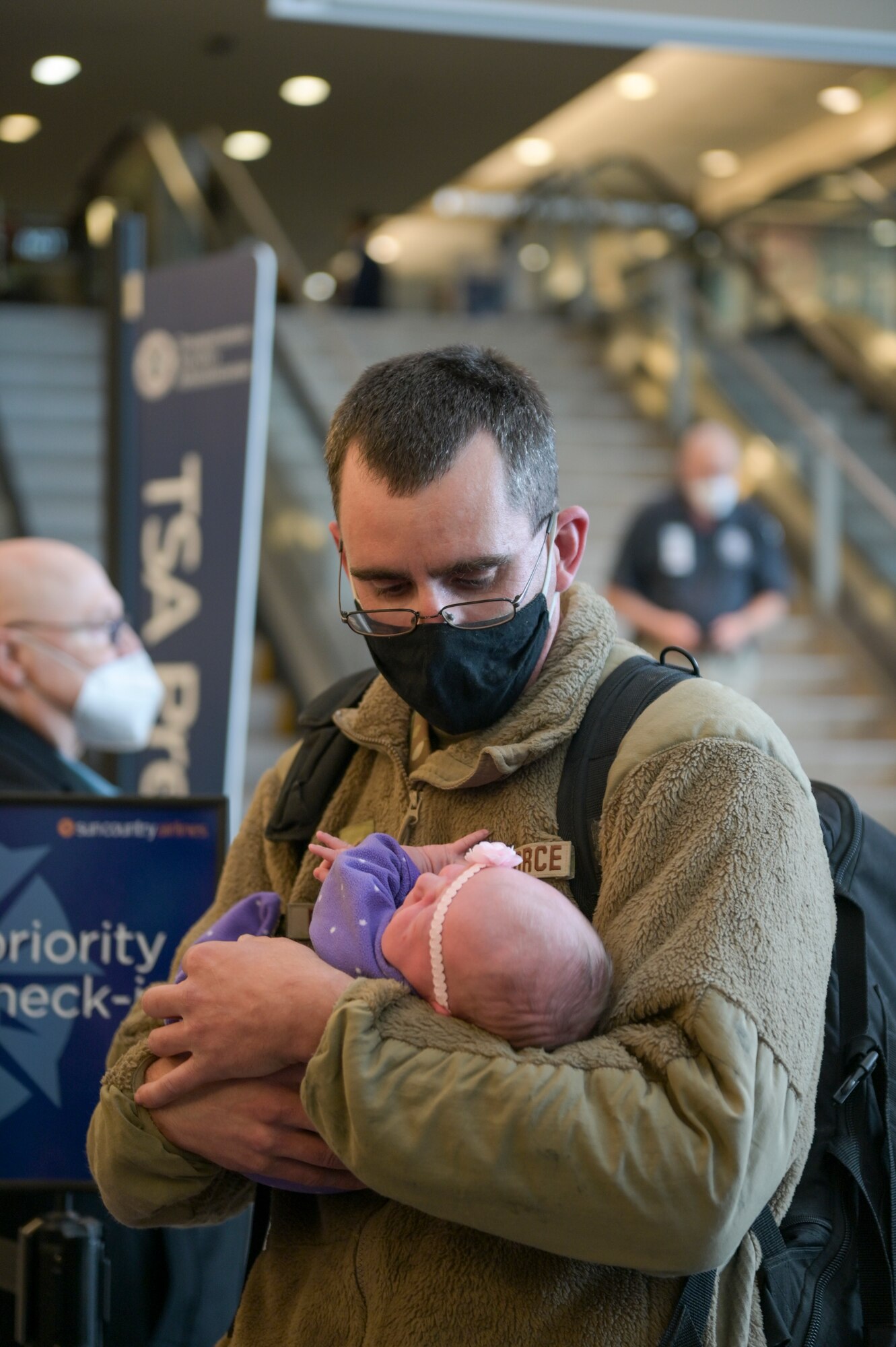 U.S. Air Force Tech. Sgt. Jeremy Rasmussen, an aircraft electrical and environmental systems technician assigned to the 115th Fighter Wing, Madison, Wisconsin, holds his newborn daughter Jan. 13, 2022 at Dane County Regional Airport. Rasmussen missed the birth while deployed overseas in support of U.S. Central Command Operations.  (U.S. Air National Guard photo by Staff Sgt. Cameron Lewis)